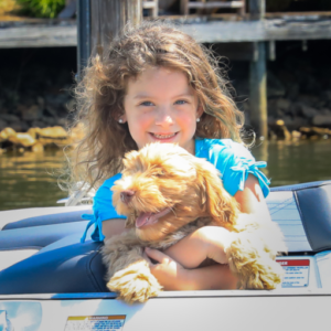 Girl with dog on boat